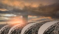 Selective focus on airport roof and blur air traffic control tower in the airport against dark cloudy sky. Steel structure of