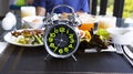 Selective focus of alarm clock  for a Healthy food of salad Intermittent fasting concept. Time to lose weight , eating control or Royalty Free Stock Photo