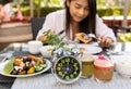 Selective focus of Alarm clock with woman eating a healthy food as Intermittent fasting, time-restricted eating-Diet breakfast