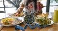 Selective focus of Alarm clock with woman eating a healthy food as Intermittent fasting, time-restricted eating-Diet breakfast