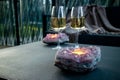 Selective focus on amethyst crystal geode candle holder with tea light candle burning inside. Royalty Free Stock Photo