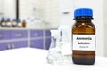 Selective focus of ammonia solution or ammonium hydroxide in glass amber bottle inside a chemistry laboratory with copy space. Royalty Free Stock Photo