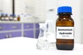 Selective focus of ammonium hydroxide or ammonia solution in glass amber bottle inside a chemistry laboratory with copy space. Royalty Free Stock Photo