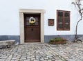 selective focus on an ancient street with a low door, window and dry vine Royalty Free Stock Photo