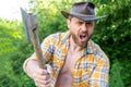 selective focus of angry lumberjack with axe. angry lumberjack with axe wearing checkered shirt Royalty Free Stock Photo
