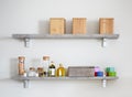 Arranged jars with various spices on kitchen shelves