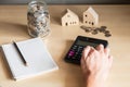Selective focus at Asian men hand using calculator to calculate saving plan or home mortgage loan to buy house. Home ownership Royalty Free Stock Photo