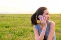 Selective focus of Asian women taking on mobile phone with green grass and sunset nature background