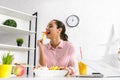 Focus of attractive girl eating paprika near laptop Royalty Free Stock Photo