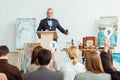 Selective focus of auctioneer holding gavel