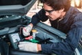 Selective focus an auto mechanic uses a multimeter voltmeter to check the voltage level in a car battery Royalty Free Stock Photo