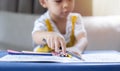 Selective focus of baby boy hands detail of a young children coloring drawing with multicolored pencils Royalty Free Stock Photo