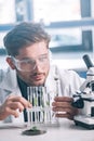 selective focus of bearded biochemist looking