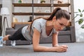 Selective focus of beautiful concentrated sportswoman doing plank exercise
