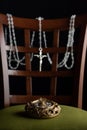 Selective focus of a beautiful glided jewelry box and a shiny necklace hanging on the chair