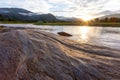 selective focus, beautiful riverside rocks, landscape, mountains, sunset, fog, clouds, mountain back, rain, clear sky, river, Royalty Free Stock Photo