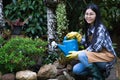 Selective focus,Beautiful young asian woman gardening in brown apronSelective focus,Beautiful young asian woman gardening in brown