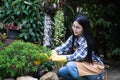 Selective focus,Beautiful young asian woman gardening in brown apron