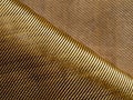 The bend of the golden fabric bulletproof material aramid. Aramid kevlar background. Golden kevlar texture and pattern Royalty Free Stock Photo