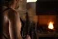 Selective focus on a blacksmith in front of his lighted forge in his workshop