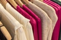 selective focus blouses and sweaters hanging from hangers in a boutique