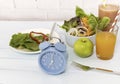 Blue clock which a Healthy breakfast and Intermittent fasting diet food concept on blue table background Royalty Free Stock Photo