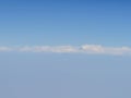 Selective focus blue sky and clouds from airplane window. Royalty Free Stock Photo