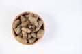 selective focus on boiled peanuts on wooden bowl isolated on white background