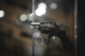 Selective focus, bokeh. background with old weapons. Revolver of old modification, close up, details of a firearm Royalty Free Stock Photo
