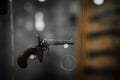 Selective focus, bokeh. background with old weapons. Revolver of old modification, close up, details of a firearm Royalty Free Stock Photo