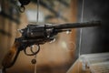 Selective focus, bokeh. background with old weapons. Revolver of old modification, close up, details of a firearm