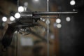 Selective focus, bokeh. background with old weapons. Revolver of old modification, close up, details of a firearm Royalty Free Stock Photo