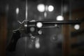 Selective focus, bokeh. background with old weapons. Revolver of old modification, close up, details of a firearm Royalty Free Stock Photo