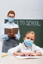 Selective focus of bored schoolgirl in Royalty Free Stock Photo