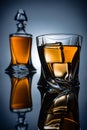 selective focus of bottle and glass with whiskey and ice cubes, Royalty Free Stock Photo