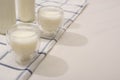 Selective focus of bottles and glasses of homemade yogurt on plaid cloth