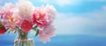 Selective focus on a bouquet of fresh tender white, pink, and red peonies in a glass vase