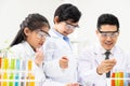 Selective focus at boy face. Young Asian boy and girl study science class using Microscope and chemical liquid to do the Royalty Free Stock Photo