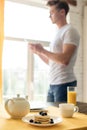 selective focus of breakfast on table and man