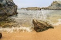 Selective focus on a breaking wave and droplets on the beach at Buizinhos beach, Porto Covo PORTUGAL Royalty Free Stock Photo