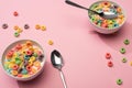 Selective focus of bright colorful breakfast cereal with milk in bowls with spoons Royalty Free Stock Photo