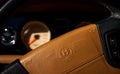 Selective focus on brown leather steering with Bentley logo wheel with blurry view on dashboard