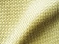 Selective focus. Bulletproof material aramid. Aramid kevlar background. Golden kevlar texture and pattern Royalty Free Stock Photo