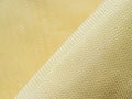 Bulletproof material aramid. Shining aramid kevlar background. Golden kevlar texture and pattern Royalty Free Stock Photo