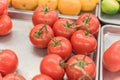 Cluster juicy tomatoes display at farmer market with price sign Royalty Free Stock Photo