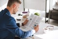 selective focus of business newspaper in hands of businessman