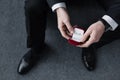 Focus of businessman holding red gift box with ring Royalty Free Stock Photo