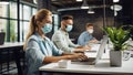 selective focus of businesswoman in medical mask using laptop while colleagues working in office