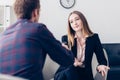 Selective focus of businesswoman in suit giving interview to journalist and gesturing Royalty Free Stock Photo