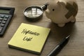 Selective focus of calculator, magnifying glass, piggy bank, pen and memo note written with Refinance Debt on wooden background